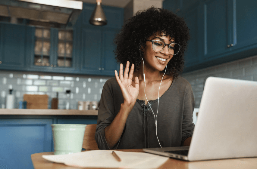 Smiling young woman on a video call on a computer.