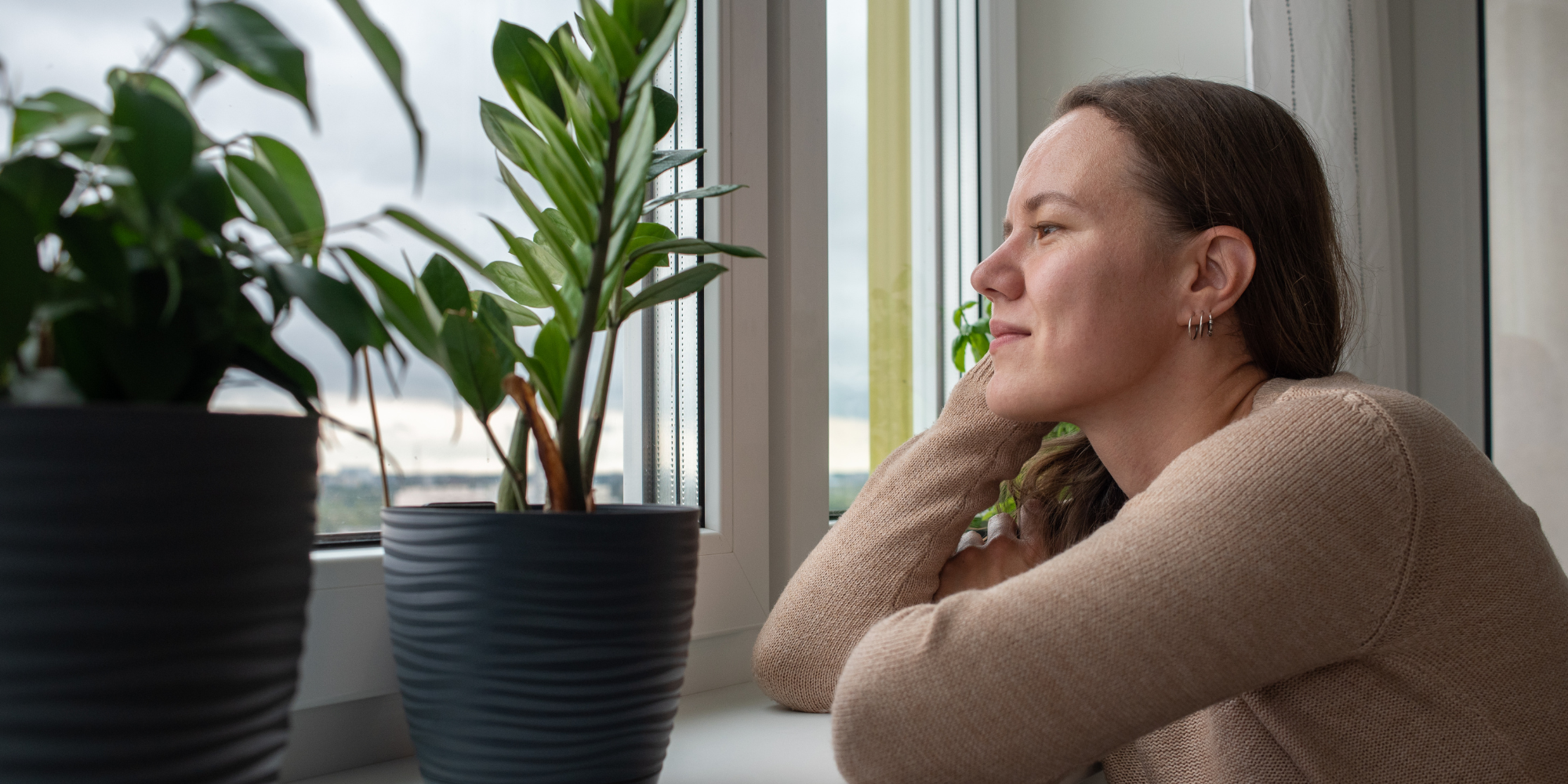 what is high-functioning depression exemplified by a woman staring out the window, looking wistful.