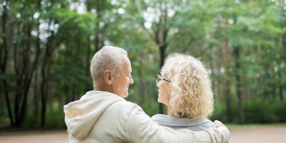 When depression and relationship distress intersect, exemplified by an older couple sitting on a park bench. They are staring into each others eyes.