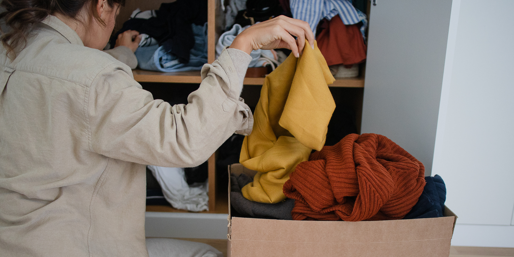 ADHD and Doom Piles represented by a woman sorting through a pile and placing things in a box.