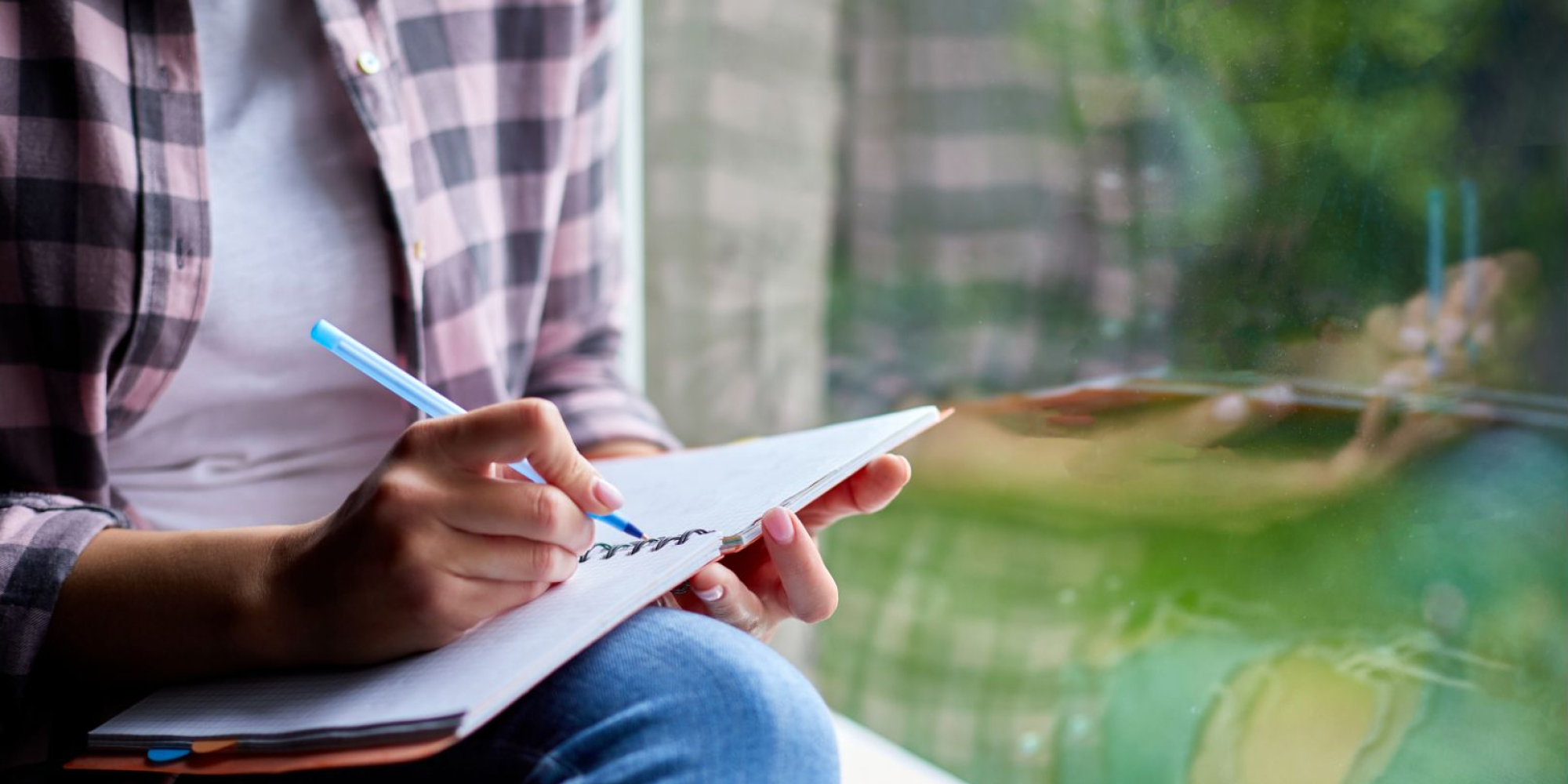 Understanding Borderline Personality Disorder, exemplified by a person writing in a journal in front of a window.