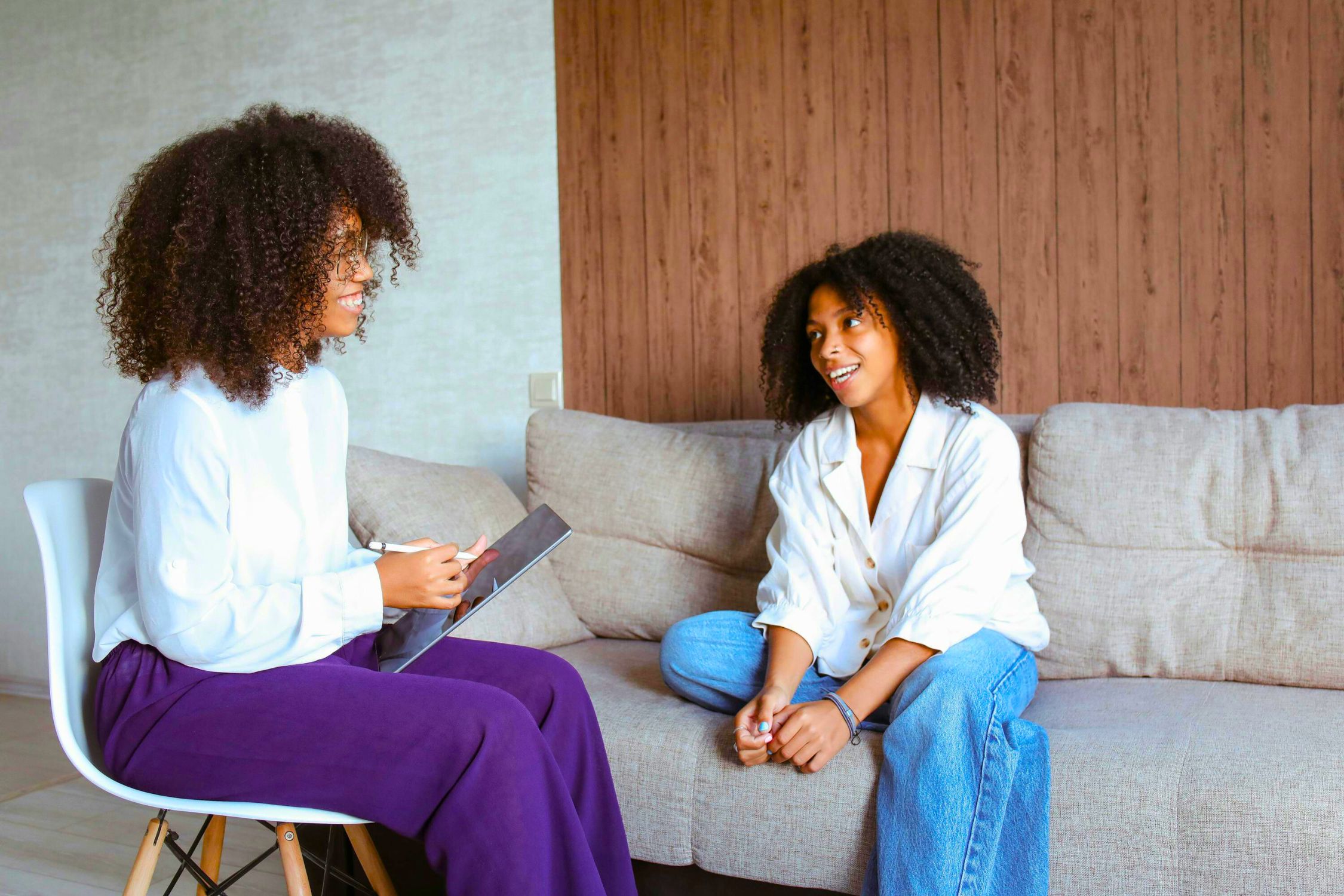 5 Ways Therapy Helps in the Journey of Self-Discovery exemplified by a therapist and young patient talking.