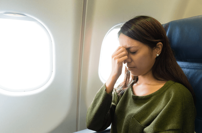 Woman on plane with fear of flying.